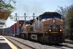 Stack train rolls west past the station